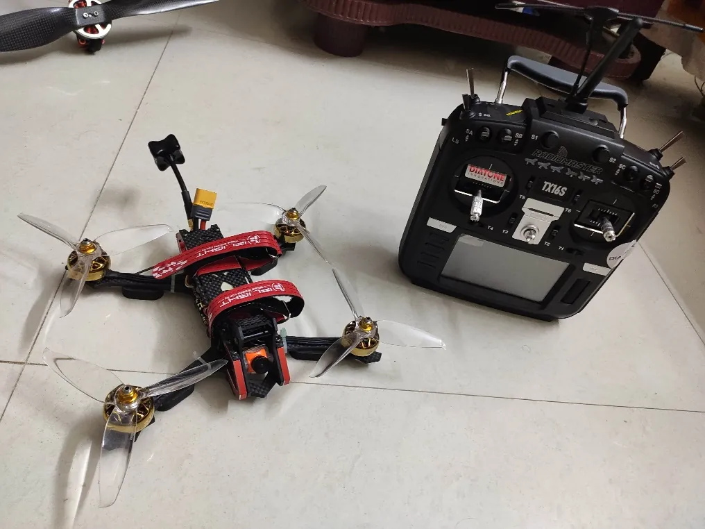 Ares high-speed FPV drone next to its radio controller
