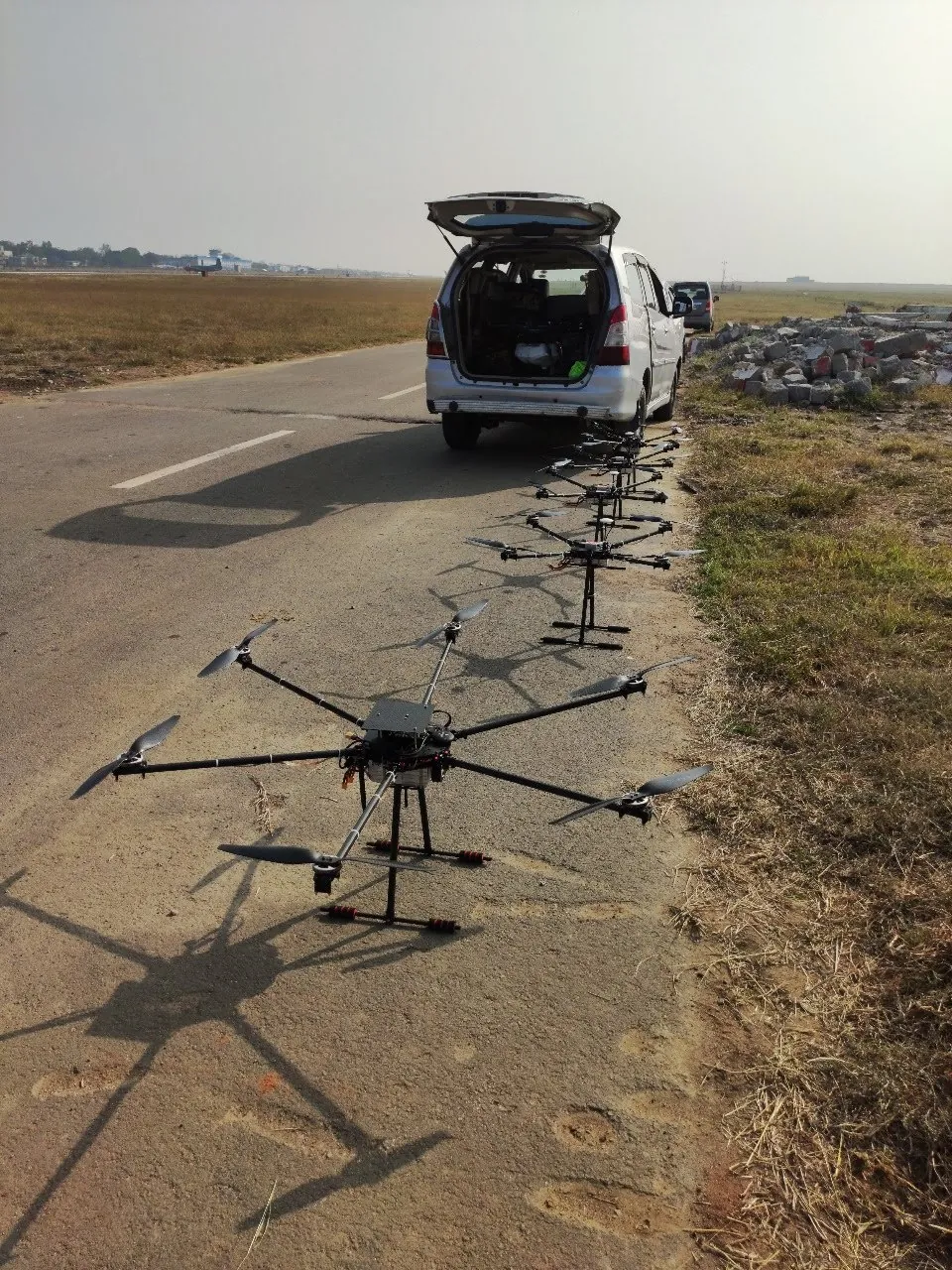 XDRPL heavy-lift drones lined up beside a runway