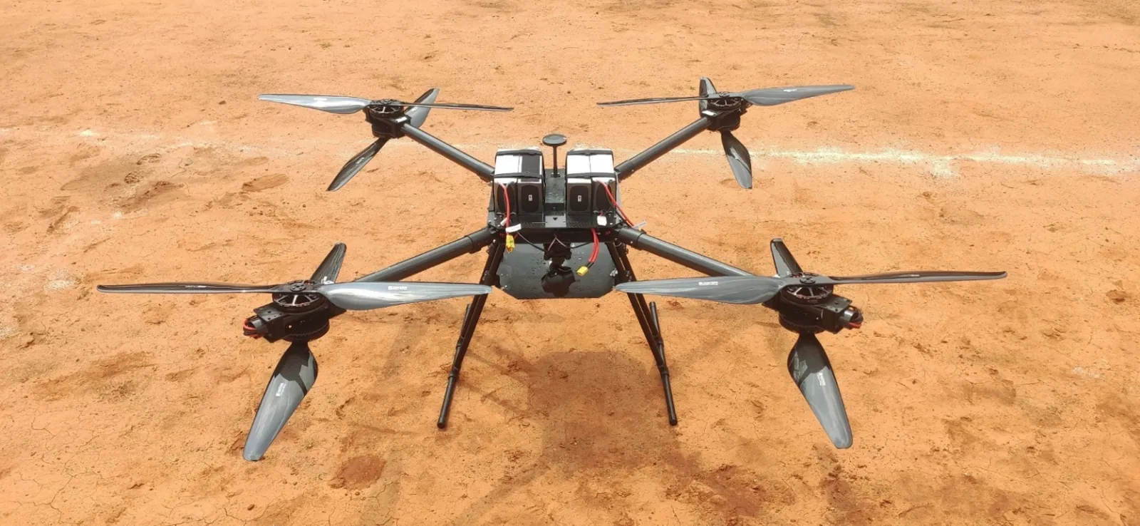Talos X8-45 heavy-lift drone on the ground with its payload release mechanism